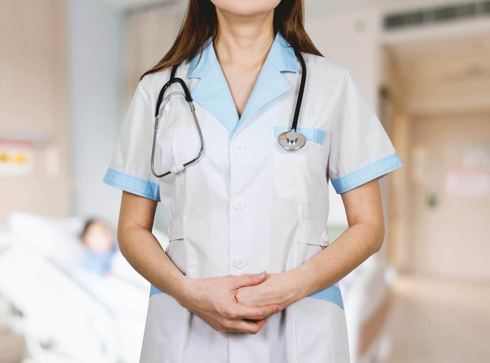 A healthcare professional in scrubs with a stethoscope